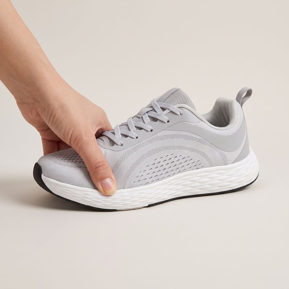 A hand flexing the Daylong sneaker