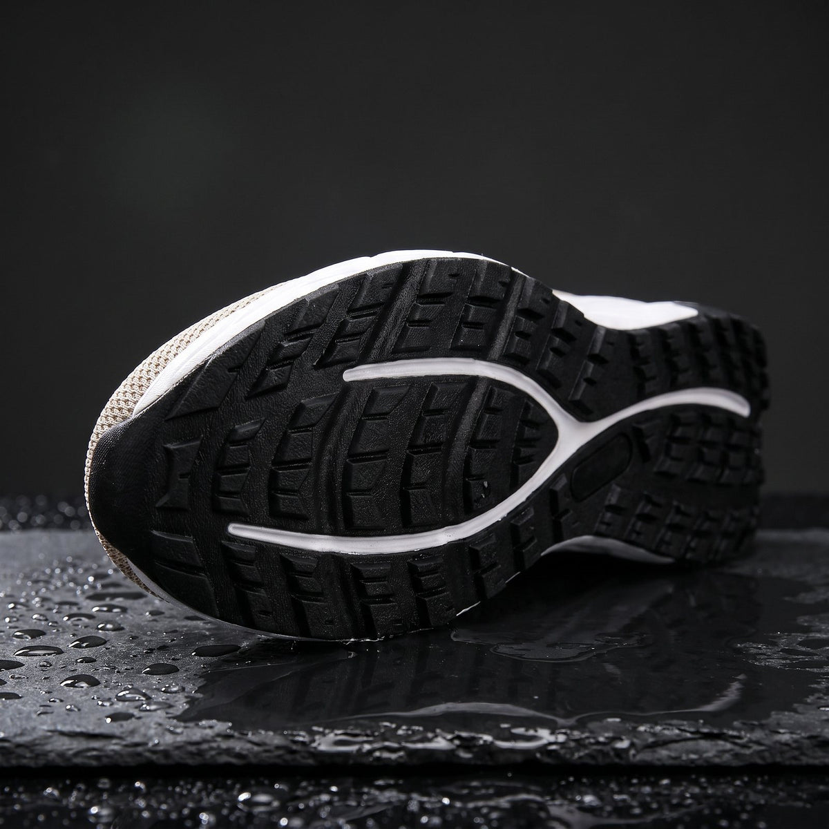 Tallgrass deep-lug rubber outsole on wet slate