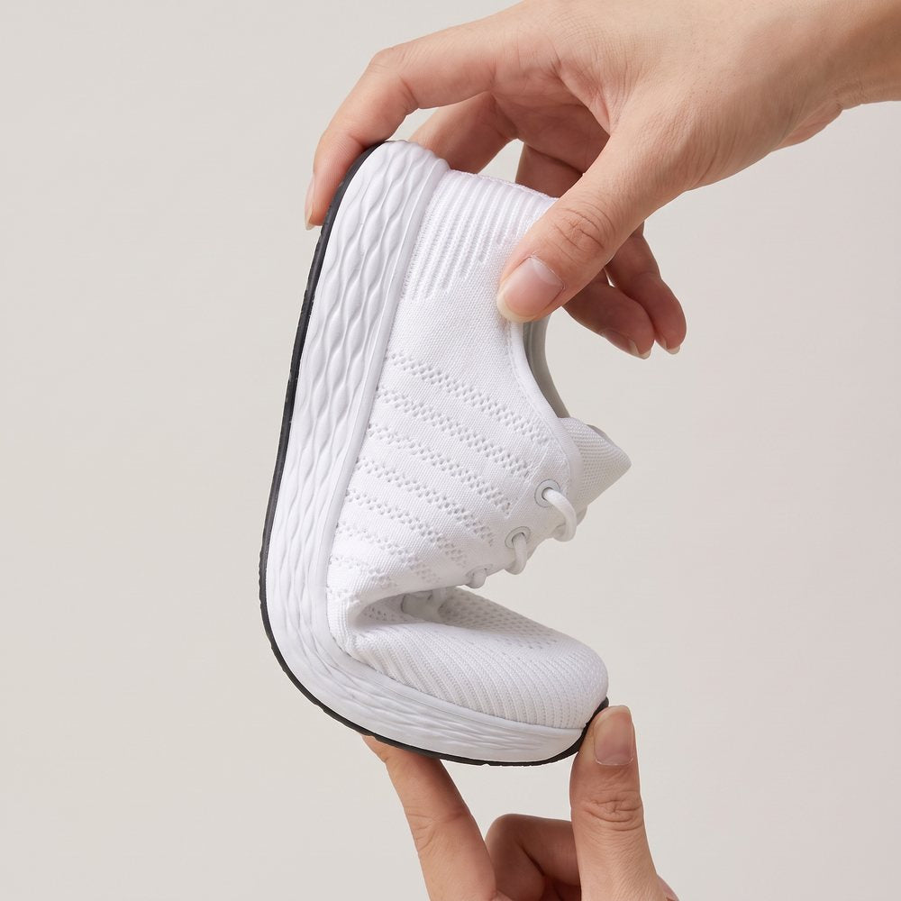 Two hands folding the Breezeway sneaker