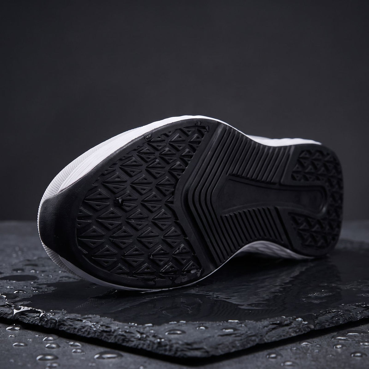 Daylong outsole with triangle tread on wet slate