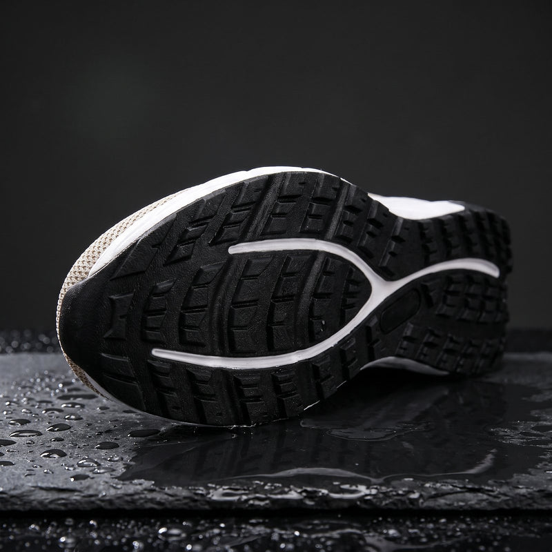 A deep-lug outsole on wet slate